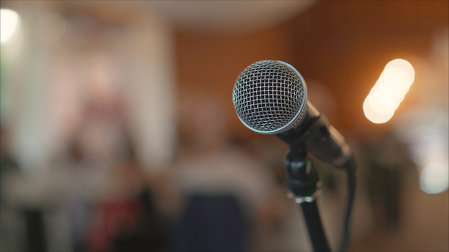 Microphone On Stage Against A Background Of Auditorium